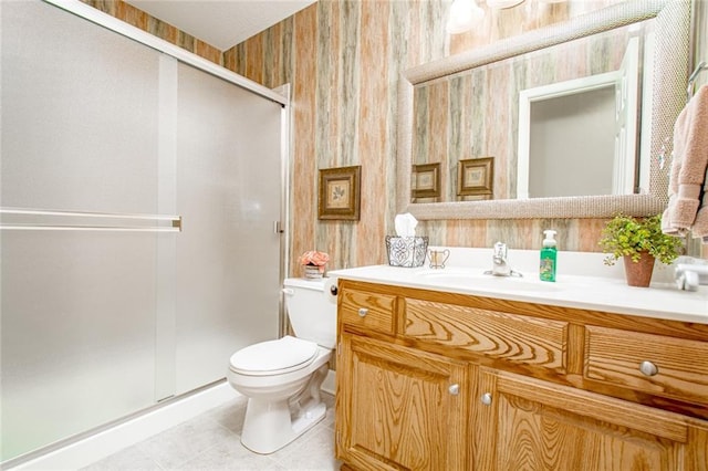 bathroom with vanity, tile patterned flooring, a shower with shower door, and toilet