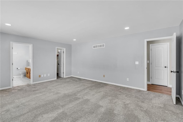 interior space with light colored carpet, visible vents, and recessed lighting