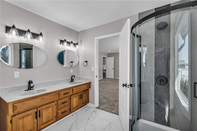 full bath with marble finish floor, double vanity, a stall shower, and a sink