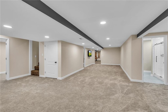 finished basement featuring stairs, recessed lighting, baseboards, and light colored carpet