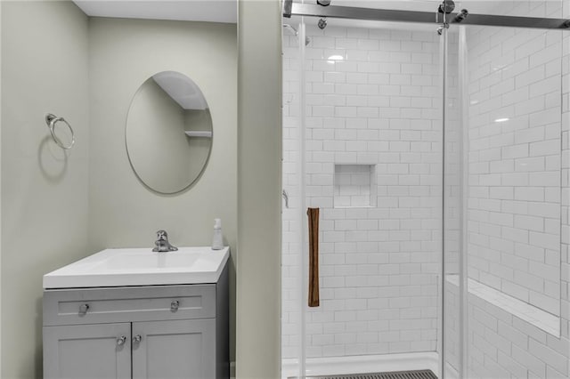 bathroom featuring a shower stall and vanity