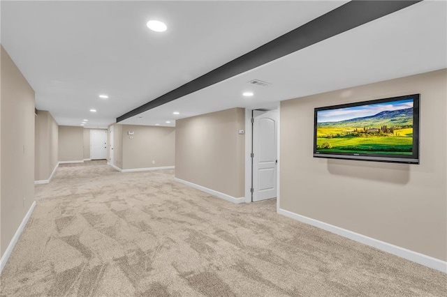 finished below grade area with light carpet, visible vents, baseboards, and recessed lighting