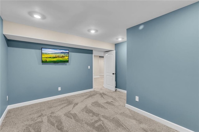 interior space featuring baseboards and light colored carpet