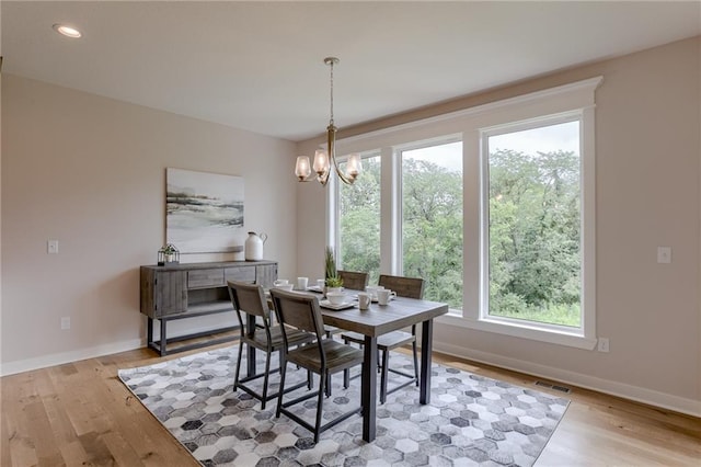 dining room with a notable chandelier and light hardwood / wood-style floors