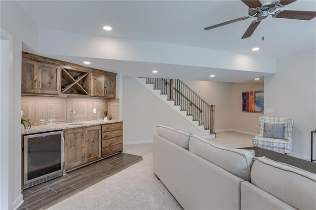 living room with beverage cooler, recessed lighting, wet bar, baseboards, and stairs