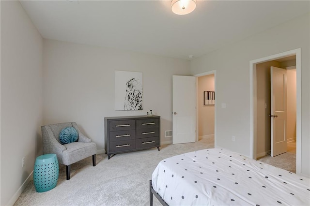 bedroom with visible vents, baseboards, and light colored carpet