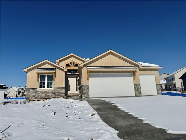 view of front of home featuring a garage and stone siding