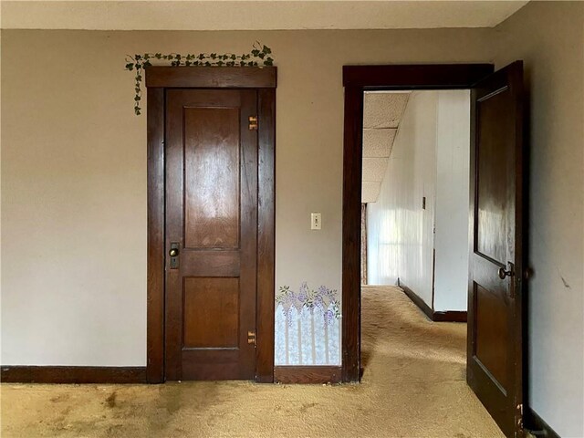 hallway with light colored carpet