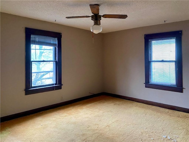 unfurnished room featuring ceiling fan, carpet floors, and a textured ceiling