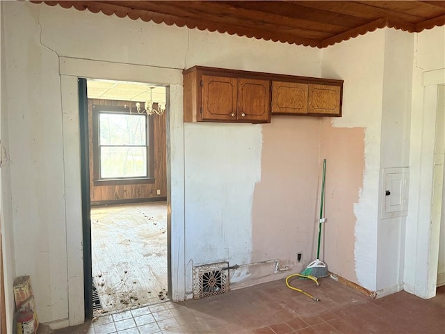 305 E 8th St, Wellsville, KS 66092 - kitchen featuring a notable chandelier and brown cabinetry