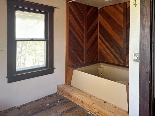 305 E 8th St, Wellsville, KS 66092 - bathroom with hardwood / wood-style floors and a tub with jets