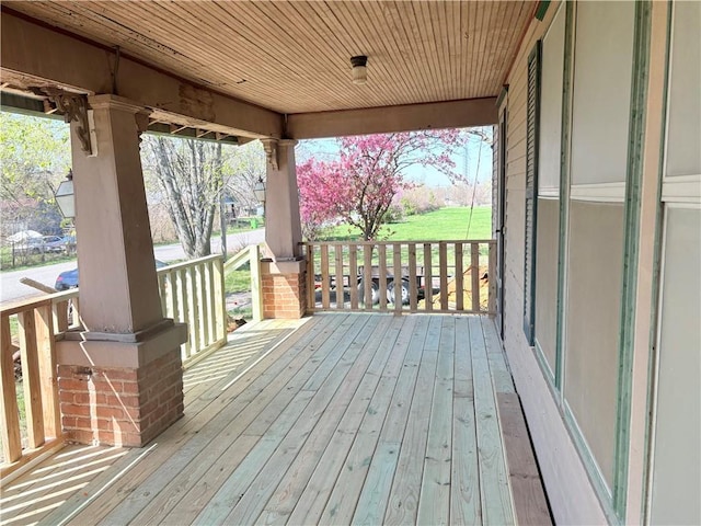 305 E 8th St, Wellsville, KS 66092 - wooden deck featuring a porch