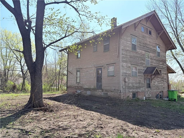 305 E 8th St, Wellsville, KS 66092 - back of house with a chimney