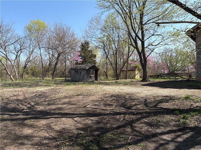 305 E 8th St, Wellsville, KS 66092 - view of yard featuring an outdoor structure and a storage unit