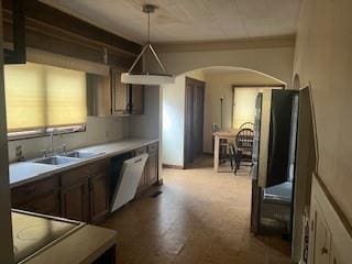 kitchen featuring white dishwasher, sink, hanging light fixtures, and black electric stovetop