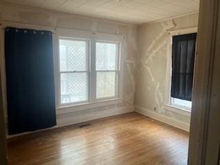 spare room featuring hardwood / wood-style flooring