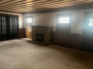 unfurnished living room featuring a fireplace and carpet