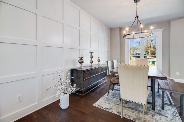 dining room featuring an inviting chandelier and dark wood-type flooring