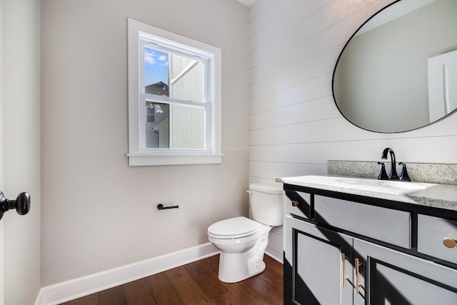 bathroom featuring hardwood / wood-style flooring, vanity, and toilet