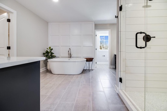 bathroom with separate shower and tub and tile patterned flooring