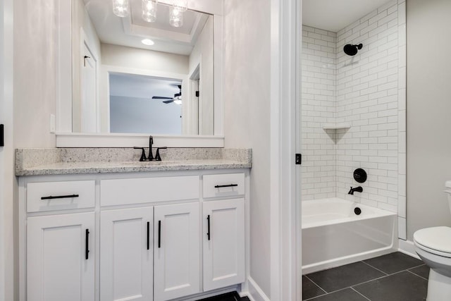 full bathroom featuring tile patterned floors, toilet, tiled shower / bath, vanity, and ceiling fan