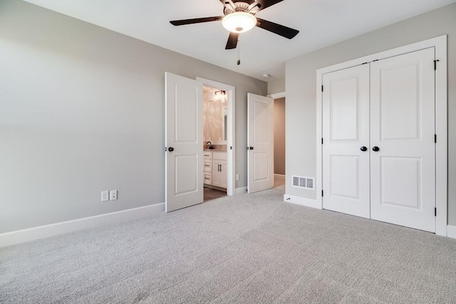 unfurnished bedroom with connected bathroom, a closet, ceiling fan, and carpet