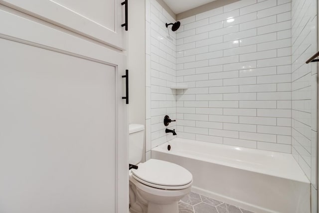 bathroom with tiled shower / bath combo and toilet