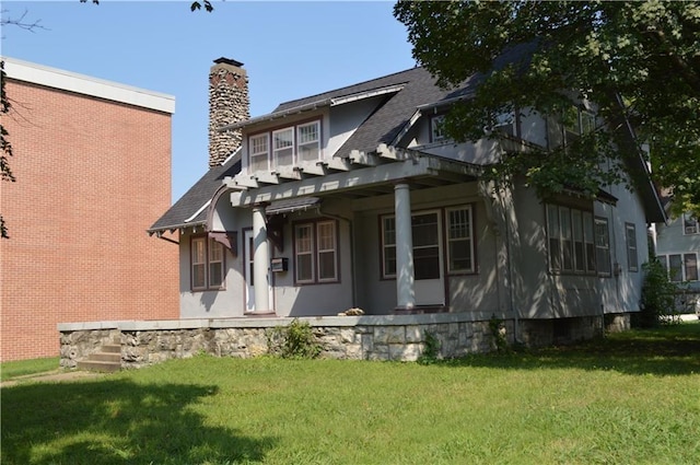 back of property featuring a lawn