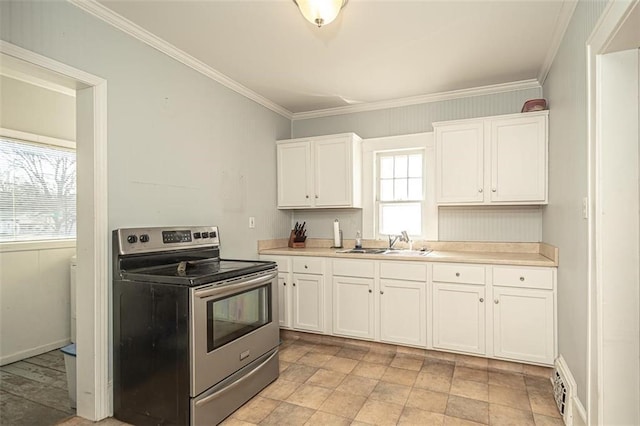 kitchen with white cabinetry, stainless steel electric range oven, sink, and ornamental molding