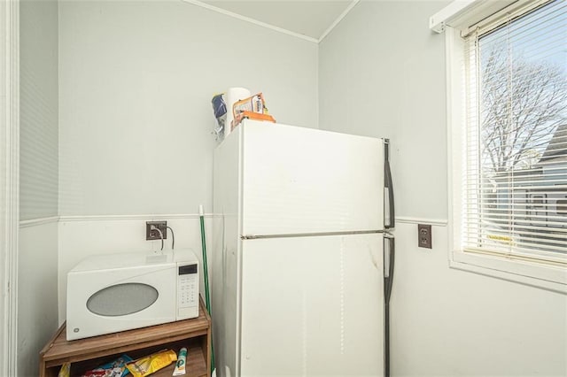 clothes washing area featuring ornamental molding