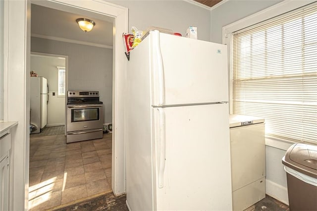 kitchen with white fridge, a healthy amount of sunlight, crown molding, and stainless steel electric range