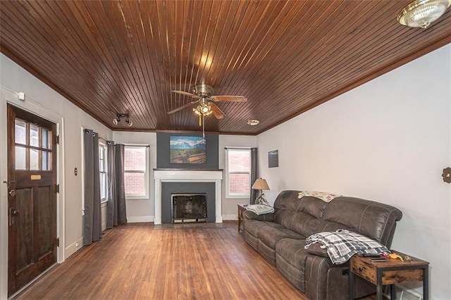 living room with hardwood / wood-style floors, crown molding, wooden ceiling, and ceiling fan