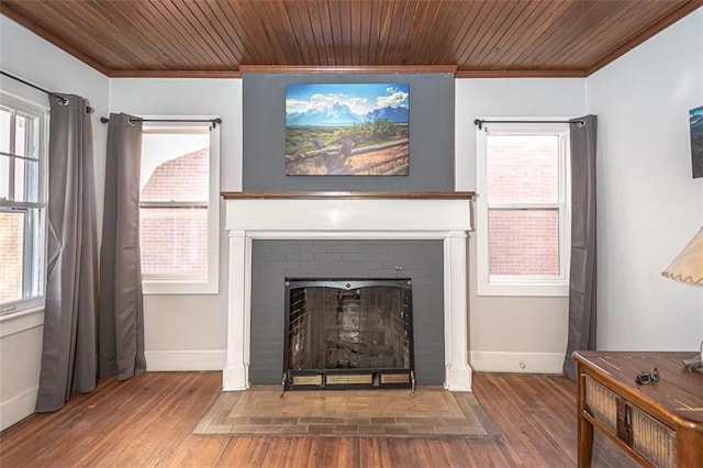 room details featuring wood ceiling, ornamental molding, wood-type flooring, and a fireplace