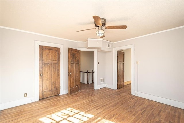 unfurnished bedroom featuring crown molding, light hardwood / wood-style floors, and ceiling fan