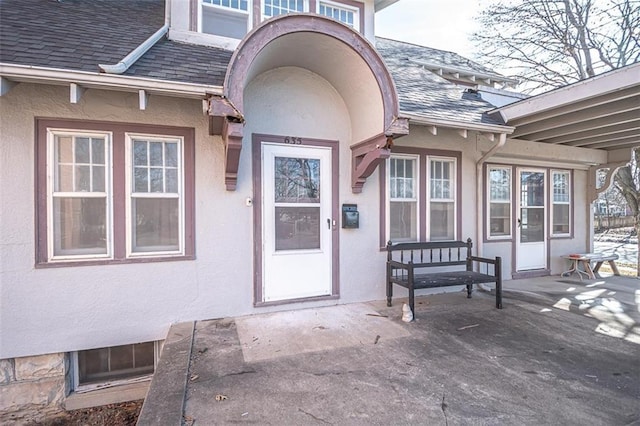 view of exterior entry featuring a patio area