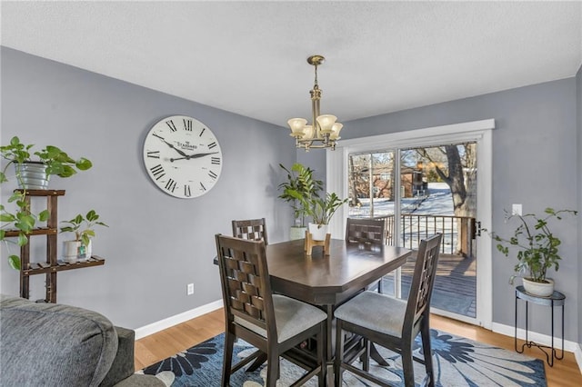 dining area featuring an inviting chandelier and wood-type flooring