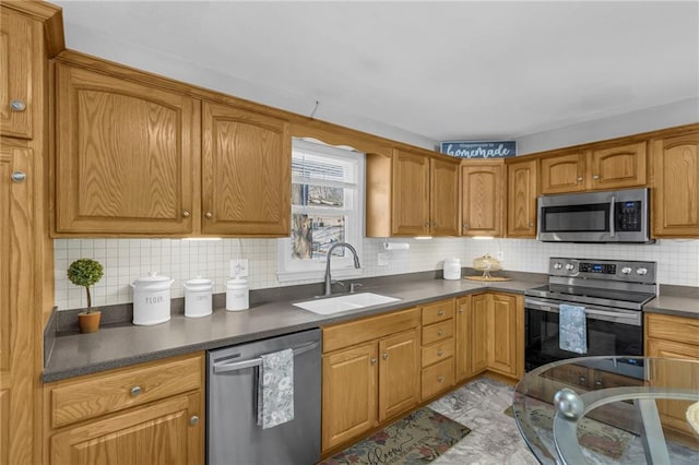 kitchen with tasteful backsplash, appliances with stainless steel finishes, and sink