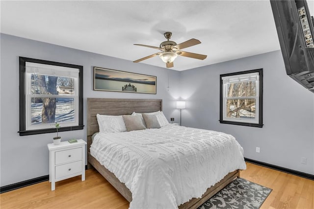 bedroom with ceiling fan and light wood-type flooring