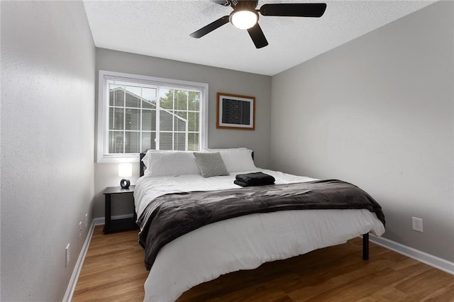 bedroom with ceiling fan and light hardwood / wood-style flooring