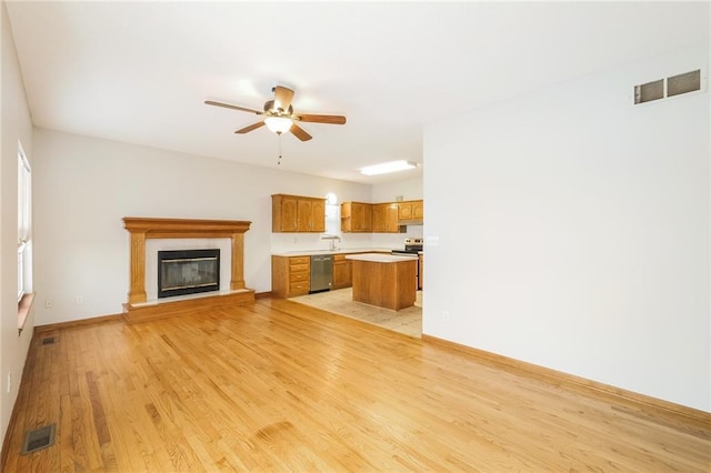 unfurnished living room with ceiling fan and light wood-type flooring