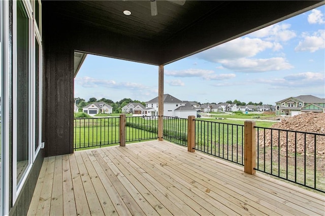 wooden terrace featuring a yard