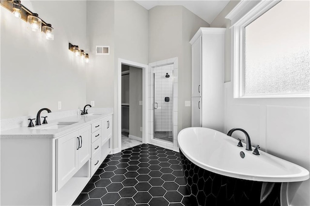 bathroom featuring tile patterned floors, vanity, and separate shower and tub