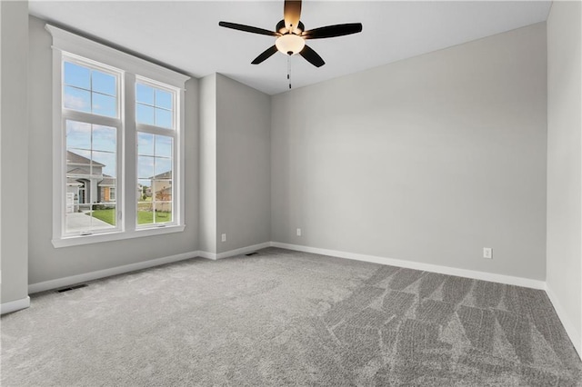 empty room featuring carpet floors and ceiling fan