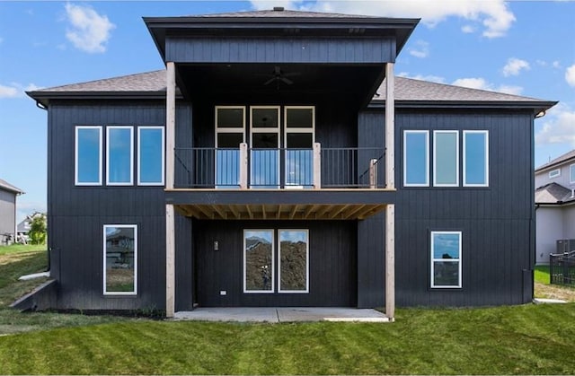 rear view of house featuring a patio, a balcony, ceiling fan, and a lawn