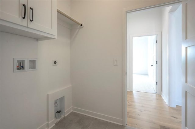 9000 N Clarion Ave, Kansas City, MO 64153 - laundry area with washer hookup, cabinet space, baseboards, hookup for an electric dryer, and light wood finished floors