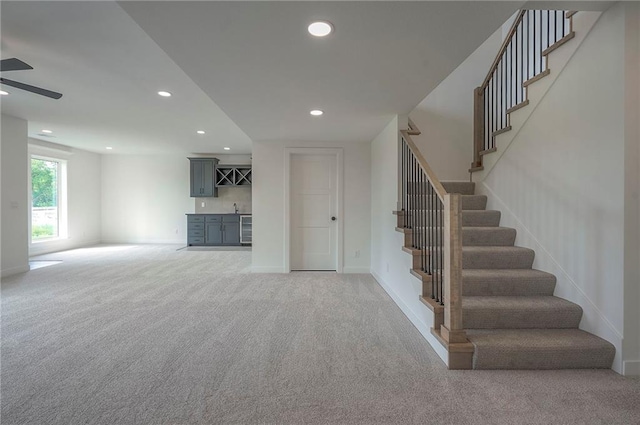9000 N Clarion Ave, Kansas City, MO 64153 - stairs with carpet, wet bar, recessed lighting, baseboards, and a ceiling fan