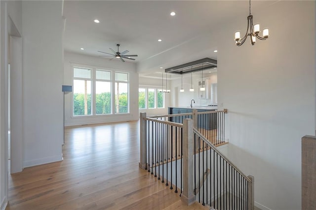 9000 N Clarion Ave, Kansas City, MO 64153 - hall featuring an upstairs landing, wood finished floors, recessed lighting, a chandelier, and baseboards