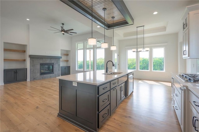 9000 N Clarion Ave, Kansas City, MO 64153 - kitchen featuring a sink, a raised ceiling, healthy amount of natural light, a tile fireplace, and recessed lighting