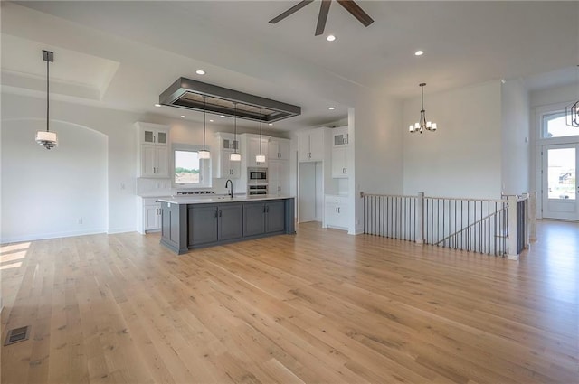 9000 N Clarion Ave, Kansas City, MO 64153 - kitchen with a tray ceiling, open floor plan, white cabinetry, and recessed lighting