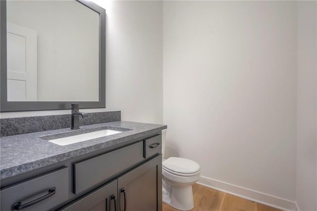 9000 N Clarion Ave, Kansas City, MO 64153 - half bath featuring wood finished floors, vanity, baseboards, and toilet